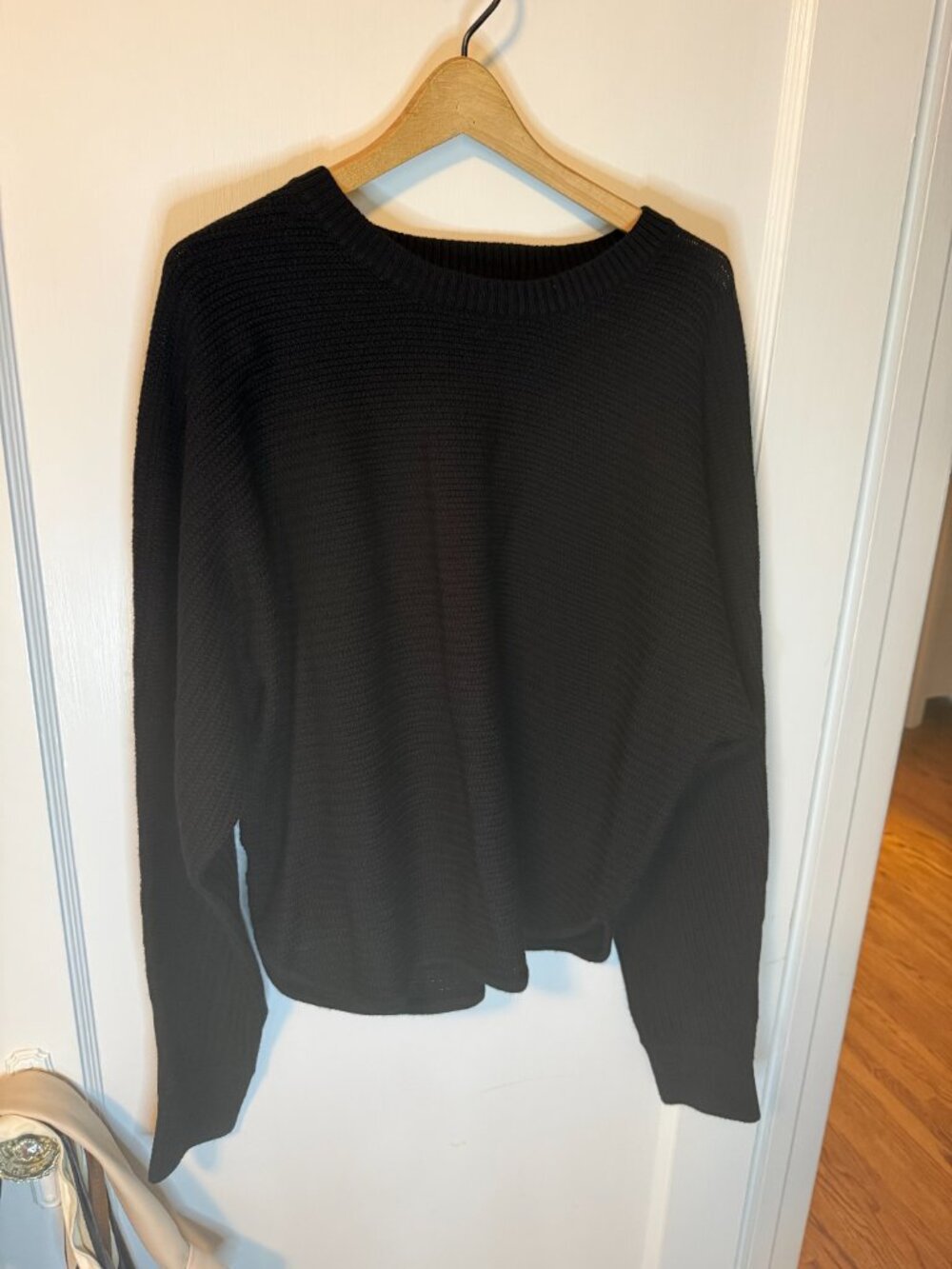 Kit and Ace merino wool sweater with metal logo on the back. Black. Size Medium
